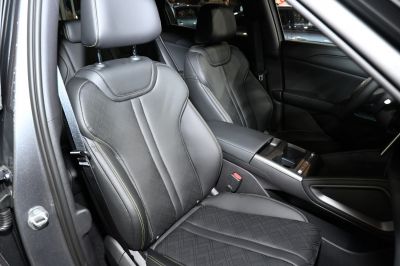 Front seats with leather upholstery and detailed stitching in an electric car interior.