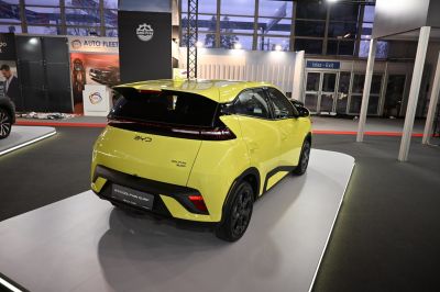 Rear view of a yellow electric hatchback with modern design