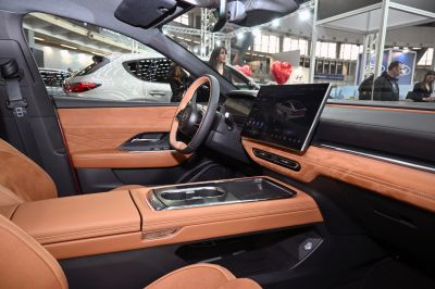 Tan leather interior with large touchscreen infotainment and modern dashboard design
