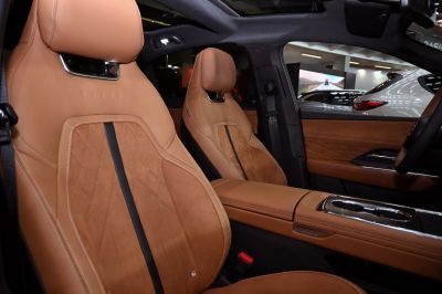 Brown leather seats with stitching and center console interior