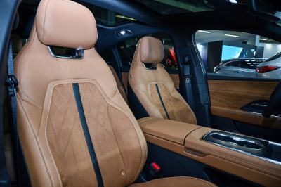 Tan leather perforated seats with diamond stitching and center console