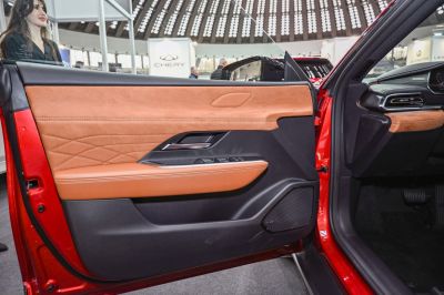 Brown leather and suede interior door panel with modern controls
