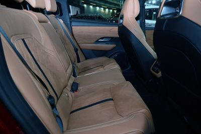 Tan leather rear seats with stitching and spacious legroom