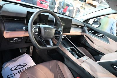 Dual digital displays and modern steering wheel in a premium car interior