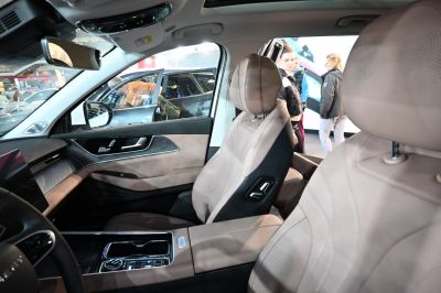 Premium beige leather seats with advanced center console and door panel.
