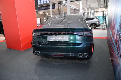 Rear view with taillights and quad exhaust pipes in a modern sedan design