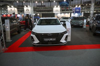 Front view of a white vehicle focusing on grille and LED headlights