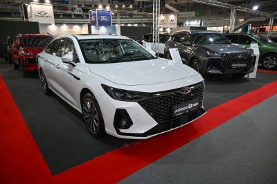 White sedan with large front grille and sharp LED headlights