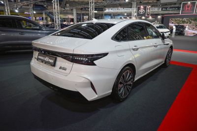 Rear and side view of a white sedan with LED taillights and aerodynamic design.