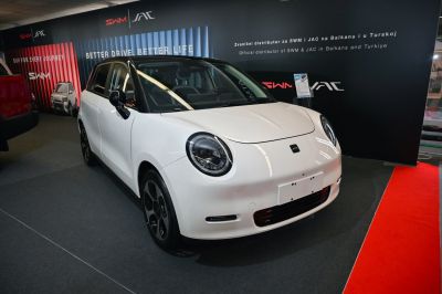 Compact electric vehicle with rounded headlights and two-tone roof