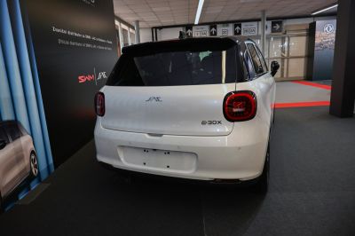 Rear view with rounded tail lights and minimalist hatchback design