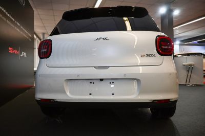 Rear design with rounded taillights and smooth hatchback.