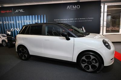 Side profile of modern compact electric hatchback with aerodynamic wheels