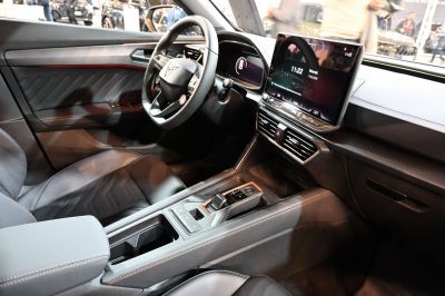 Digital cockpit and large infotainment touchscreen in modern car interior.