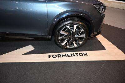 Close-up of a modern alloy wheel and tire on a car's front side.