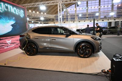 Electric SUV side view with charging cable and modern alloy wheels