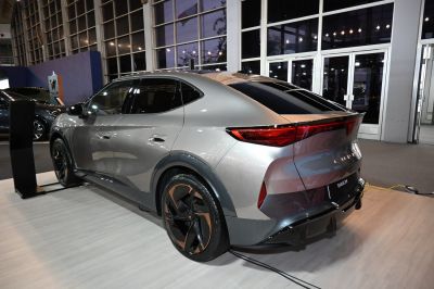 Rear view of a modern SUV coupe with sharp taillights and two-tone alloy wheels.