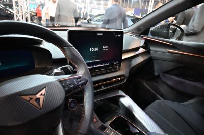 Digital dashboard and central touchscreen with steering wheel controls inside a modern car interior