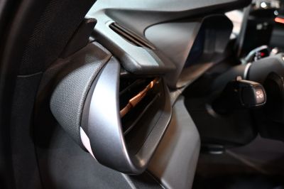 Driver side air vent and control lever close-up in car interior
