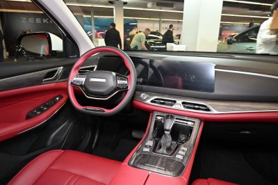 Red leather interior with digital dashboard and automatic gear shifter
