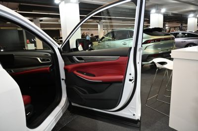 Red and black interior door panel with wood trim and power window controls