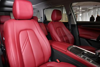 Red leather front seats with detailed stitching and modern design
