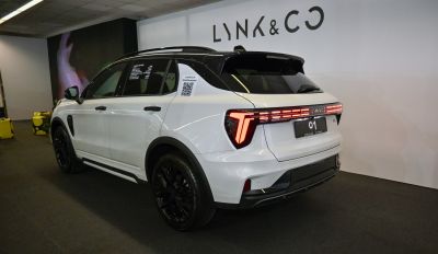 T-shaped LED taillights and black alloy wheels on white SUV rear