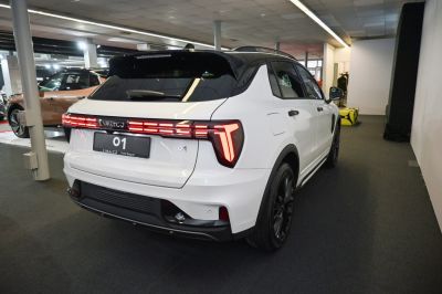 Modern LED rear lights and black roof on a white SUV rear