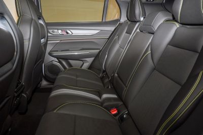 Rear seat interior with black upholstery and yellow stitching