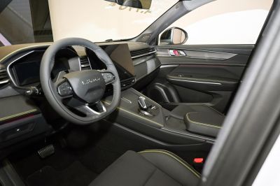 Modern car interior with digital dashboard and yellow stitching details