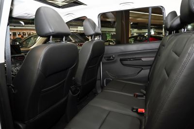 Black leather rear seats with headrests and spacious cabin.