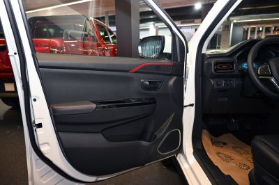 Car interior door panel with red trim and window control buttons
