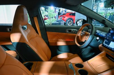Tan leather seating and premium digital dashboard with infotainment screens