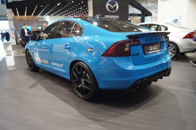 Blue sedan with black wheels and rear spoiler