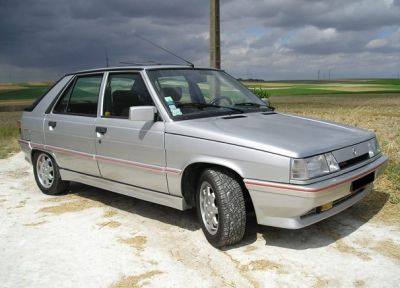 Silver 5-door hatchback with alloy wheels and side detail striping