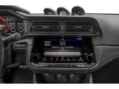 Digital infotainment screen and dashboard gauges with climate controls