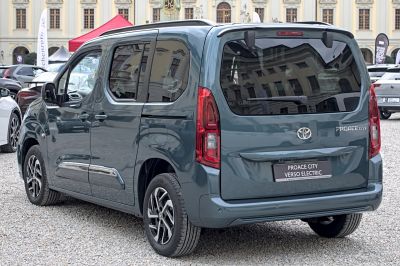 Rear-side view of a compact electric MPV with distinctive taillights and tinted windows