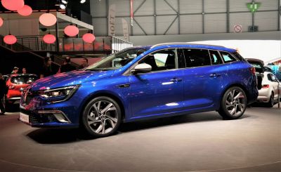 Blue compact station wagon with sporty alloy wheels and aerodynamic design