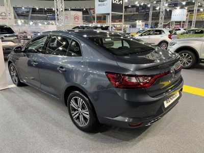 Rear and side profile of a gray sedan with modern taillights and alloy wheels.