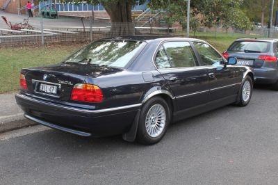 Rear side view of classic long-wheelbase sedan with alloy wheels and taillights