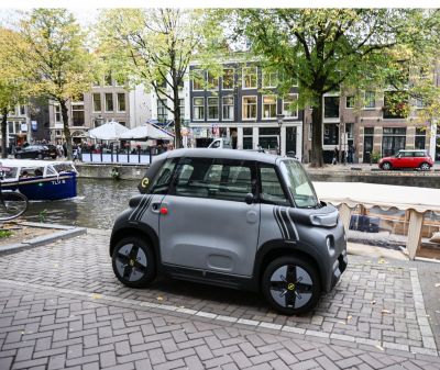 Compact electric urban vehicle with a modern small hatchback design.