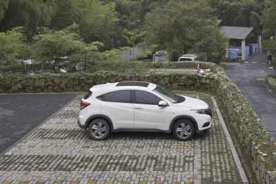Side view of a white compact SUV with sunroof and tinted windows