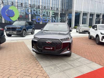 Bold front grille and sleek headlights of an SUV at a display event.