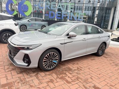 Silver sedan with bold front grille, LED headlights, and detailed alloy wheels