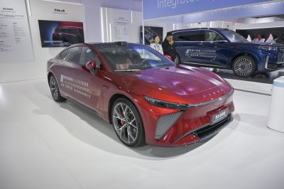 Aerodynamic front fascia with sharp LED headlights on a sleek electric sedan