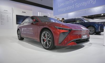 Sleek red electric sports sedan with liquid metal paint and aerodynamic design