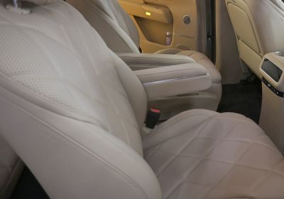 Beige leather seats with armrest and detailed stitching