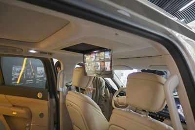 Beige interior with overhead drop-down entertainment screen visible