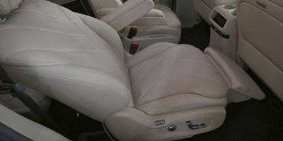 Luxury beige leather rear seat with adjustable legrest and electronic controls