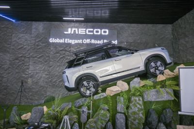 Off-road SUV climbing rocky slope with roof rack and cargo carrier